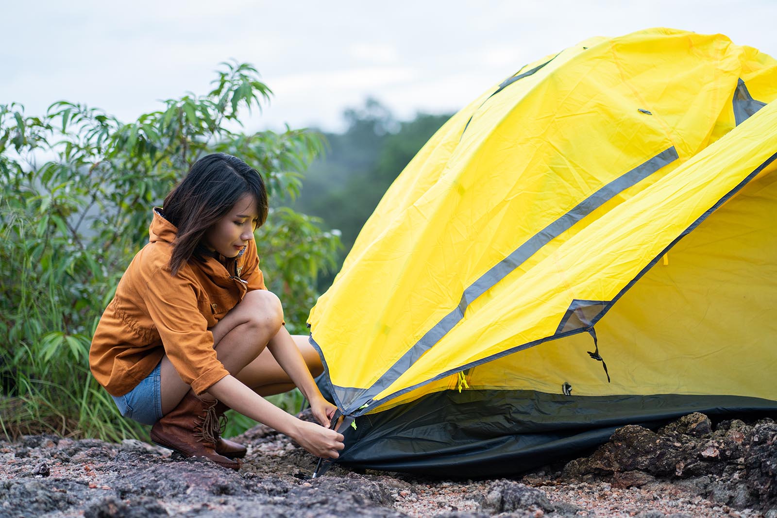 woman anchoring tent